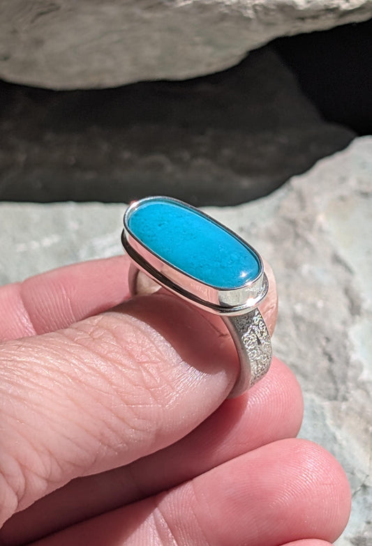 silver fused ring with a vibrant blue gemstone called gem silica set in east west horizontal direction modern